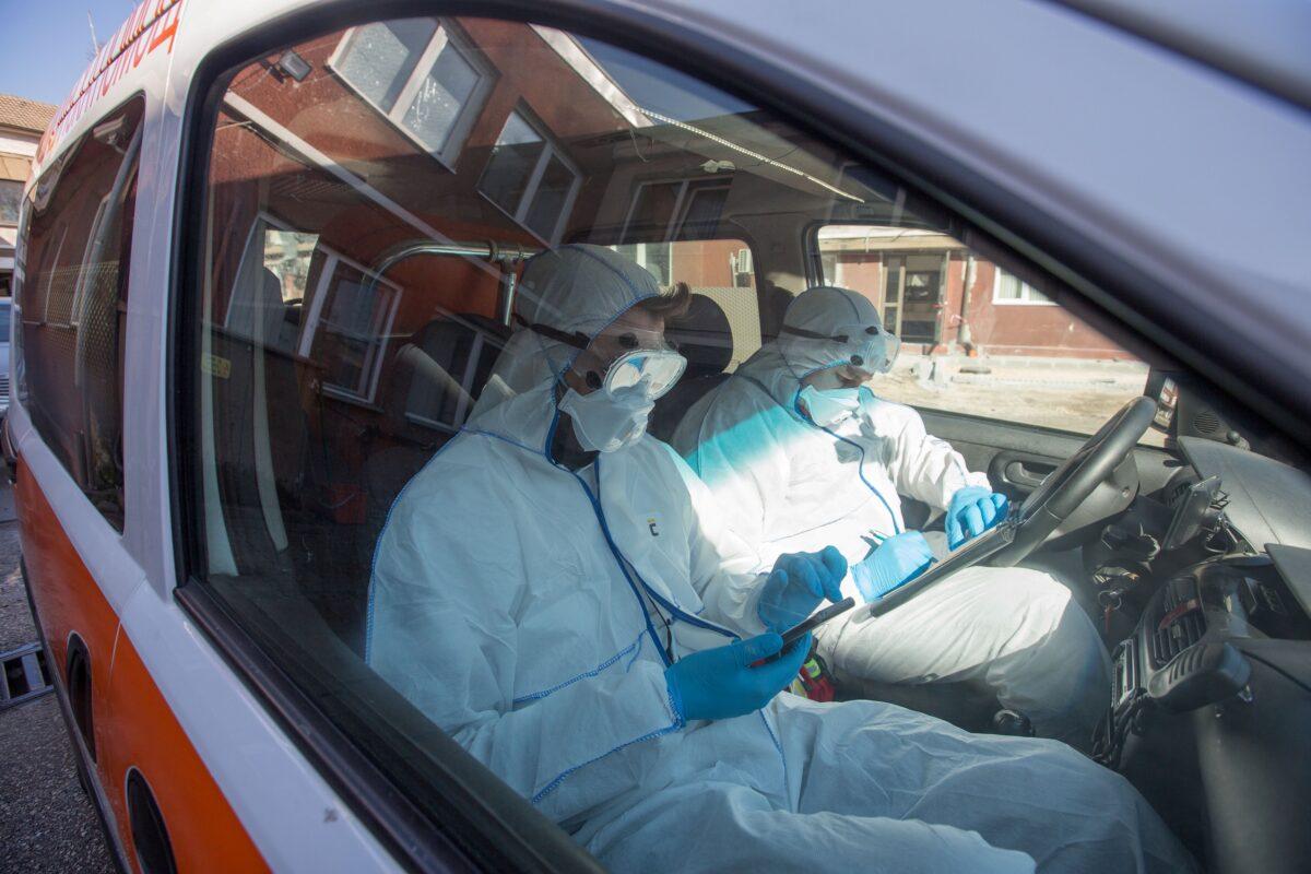 A medical team in full protective outfits are on the way to a possible coronavirus infection in Sofia, Bulgaria March 13, 2020. (Dimitar Kyosemarliev/Reuters)