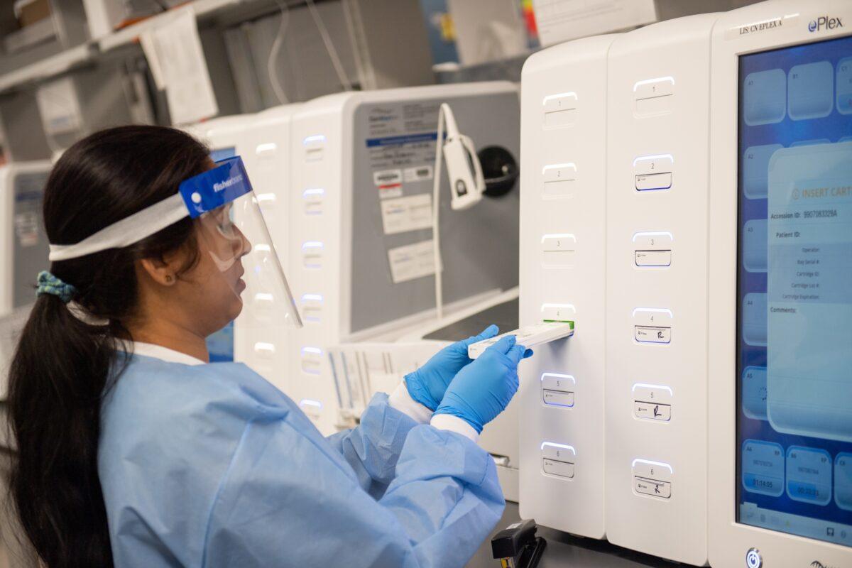 A lab technician begins semi-automated testing for COVID-19 at Northwell Health Labs in Lake Success, New York on March 11, 2020. (Andrew Theodorakis/Getty Images)