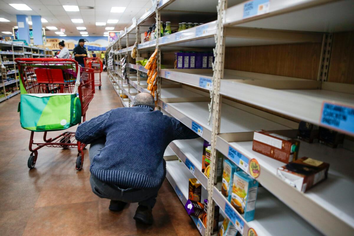 Shoppers browse barren shelves at a supermarket in Larchmont, N.Y. on Friday, March 13, 2020. (John Minchillo/AP Photo)