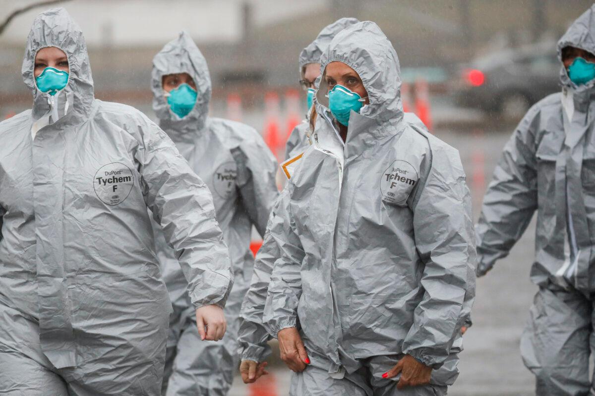 Medical personnel arrive to perform COVID-19 infection testing procedures at Glen Island Park in New Rochelle, N.Y. on Friday, March 13, 2020. (John Minchillo/AP Photo)
