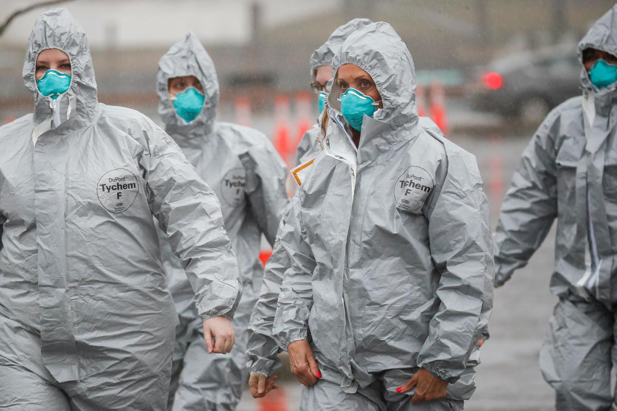 Medical personnel arrive to perform COVID-19 infection testing procedures at Glen Island Park in New Rochelle, New York, on March 13, 2020. (John Minchillo/AP Photo)