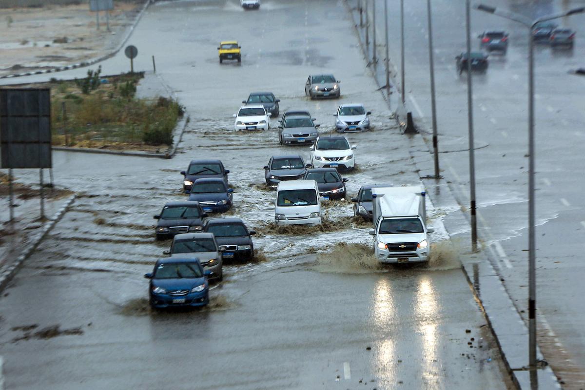 Cars drive along a flooded motorway in the New Cairo suburb of the Egyptian capital, Cairo, Egypt, on March 12, 2020. (AFP via Getty Images)