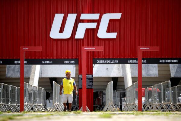 A man walks in front of the Nilson Nelson Gymnasium as the next UFC Fight Night will be held without fans during the fights, after reports of the coronavirus in Brasilia, Brazil, March 12, 2020. (Reuters/Adriano Machado/File Photo)