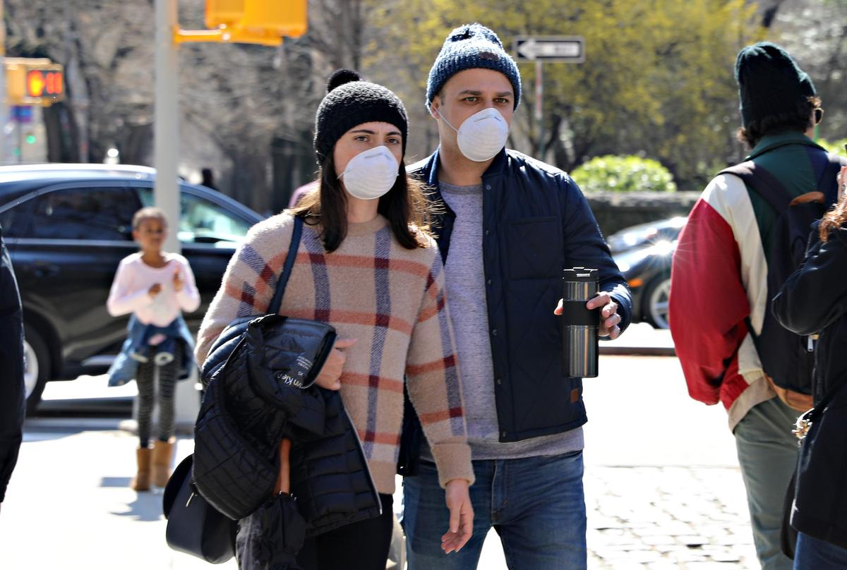 A couple wearing protective masks are seen on Fifth Avenue in New York City on March 13, 2020. (Cindy Ord/Getty Images)