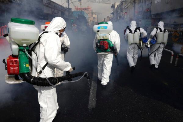 Firefighters disinfect a street against the new CCP virus, in western Tehran, Iran, on March 13, 2020. (Vahid Salemi/AP Photo)