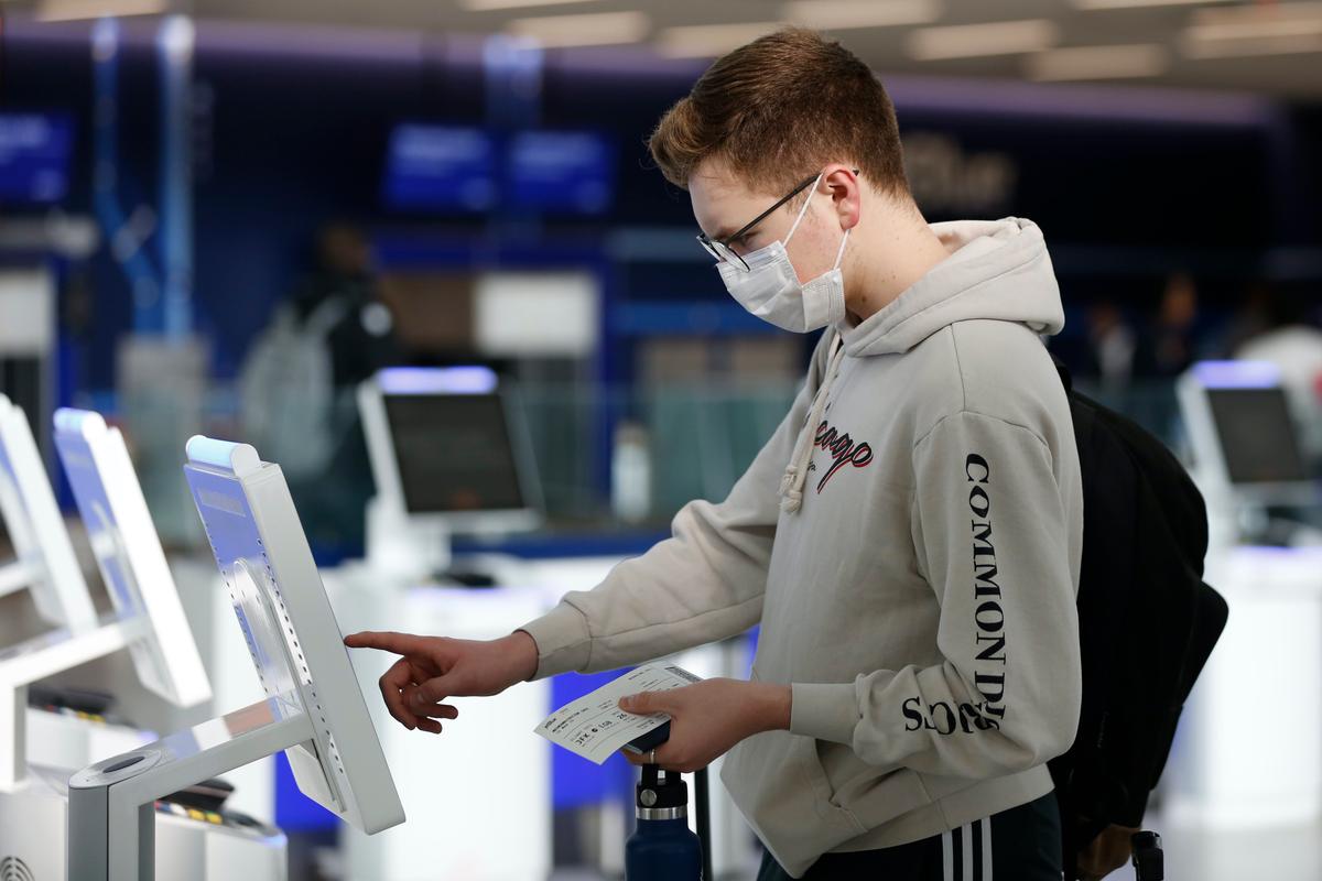 A passenger checks in using a touchscreen at JetBlue's terminal in John F. Kennedy International Airport, in New York City on March 14, 2020. (Kathy Willens/AP Photo)
