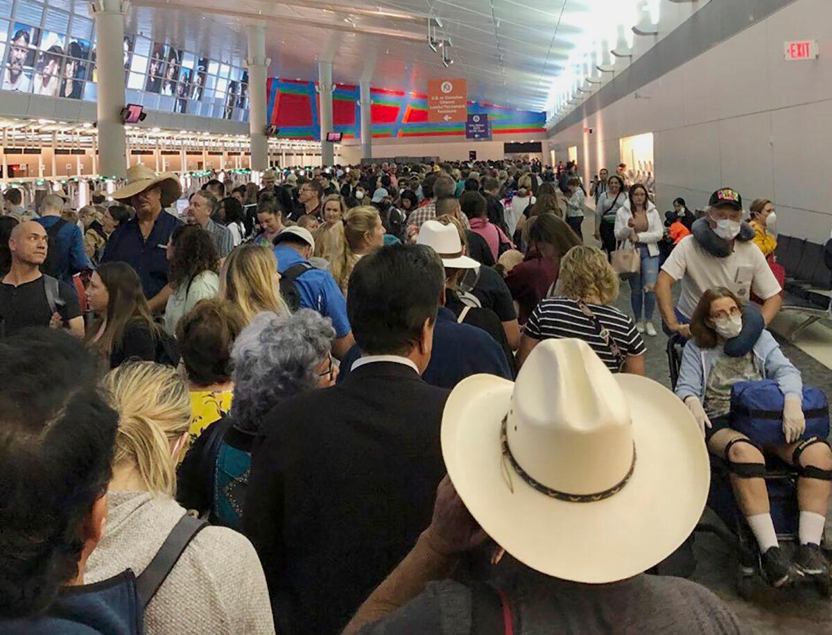 People wait in line to go through the customs at Dallas Fort Worth International Airport in Grapevine, Texas, on March 14, 2020. (Austin Boschen via AP)
