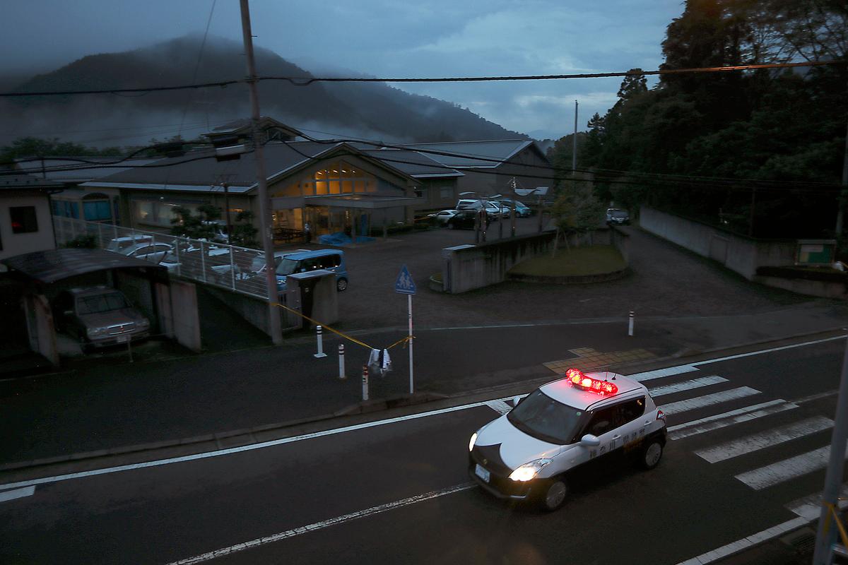 A police car patrols at night in front of the Tsukui Yamayuri-en, a facility for the people with mental disabilities where a former care home employee killed 19 people, in Sagamihara, outside Tokyo, Japan, on July 26, 2016. (Eugene Hoshiko/File/AP Photo)