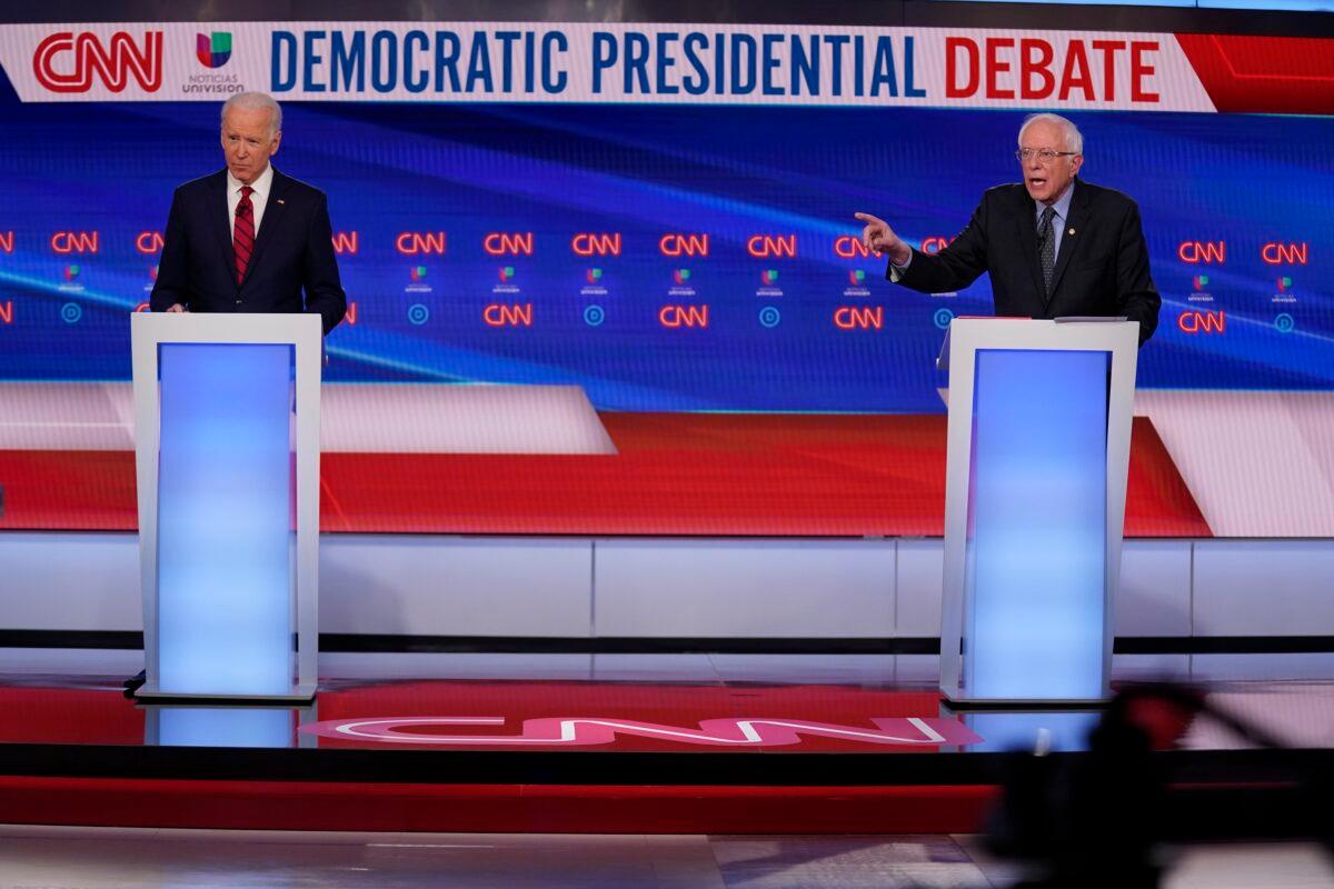 Former Vice President Joe Biden, left, and Sen. Bernie Sanders (I-Vt.) right, participate in a Democratic presidential primary debate at CNN Studios in Washington on March 15, 2020. (Evan Vucci/AP Photo)