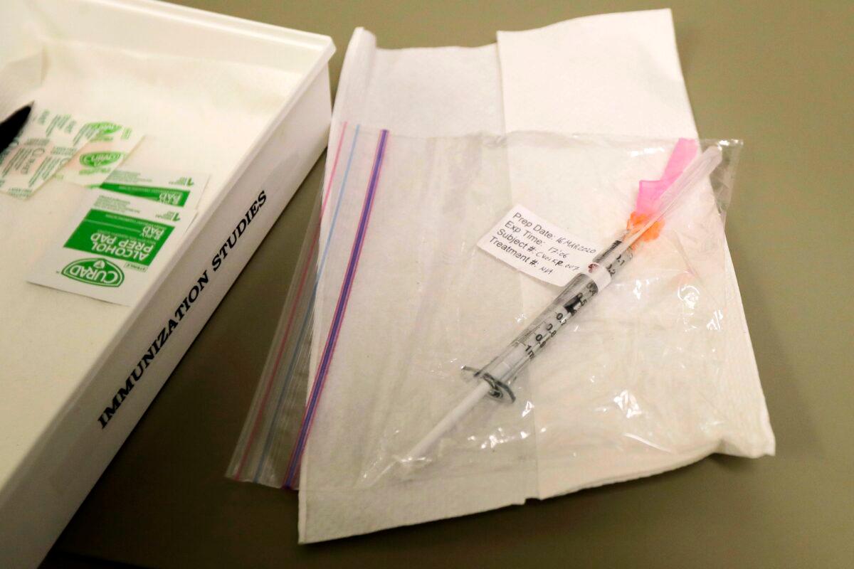 A syringe containing the first shot given in the first-stage safety study clinical trial of a potential vaccine for COVID-19, the disease caused by the new coronavirus, rests on a table at the Kaiser Permanente Washington Health Research Institute in Seattle on March 16, 2020. (Ted S. Warren/AP Photo)