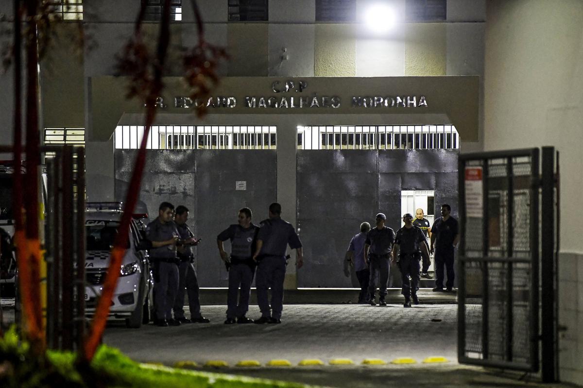 Military police officers are seen at the main entrance of the Doctor Edgar Magalhaes Noronha (Pemano) Penitentiary during a riot in Tremembe, 155 km from Sao Paulo, Brazil, early on March 17, 2020. (Photo by Lucas Lacaz/AFP via Getty Images)