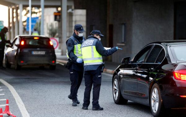 A Spanish police officers check a car at the border between Portugal and Spain, following an order from the Spanish government to set up controls at its land borders over coronavirus, in Vilar Formoso, Portugal, on March 17, 2020. (Rafael Marchante/Reuters)