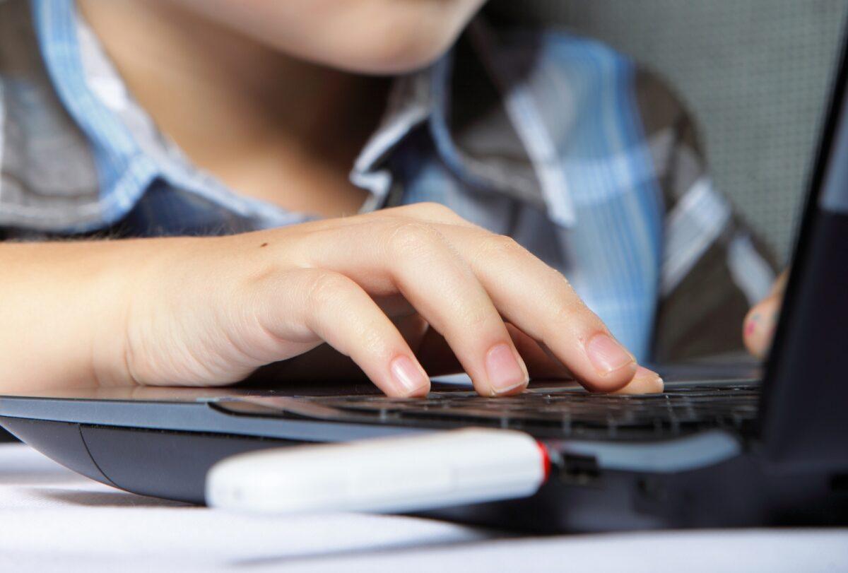 A young boy uses a laptop computer in this file photo illustration. (Shutterstock)