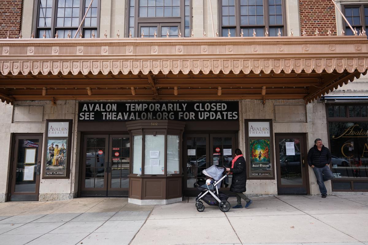 A message is seen on the sign above the Avalon Theatre temporarily closed due to the coronavirus in Washington on March 17, 2020. (Mandel Ngan/AFP via Getty Images)