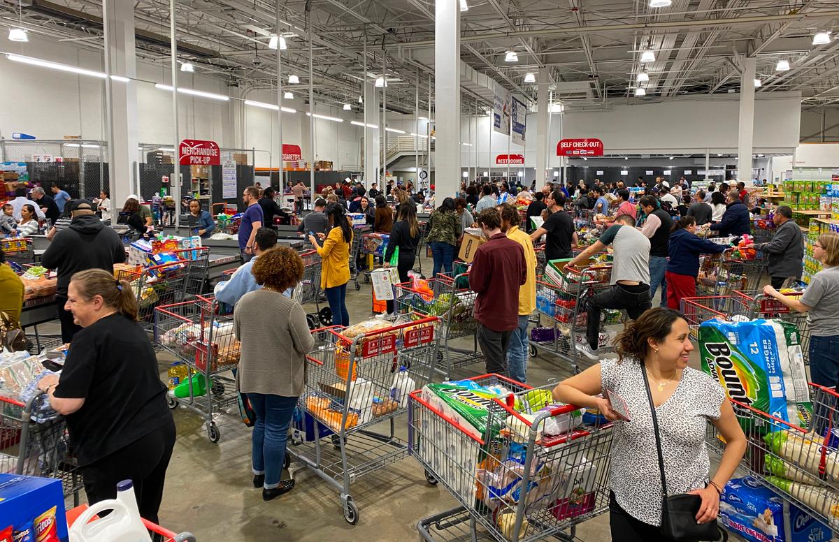 Shoppers line up with full carts in a supermarket in Virginia on March 13, 2020. (Daniel Slim/AFP via Getty Images)