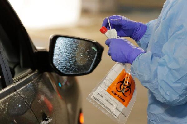 A nurse at a drive-through coronavirus testing station in Seattle, Washington, on March 13, 2020, (Ted S. Warren/AP Photo)