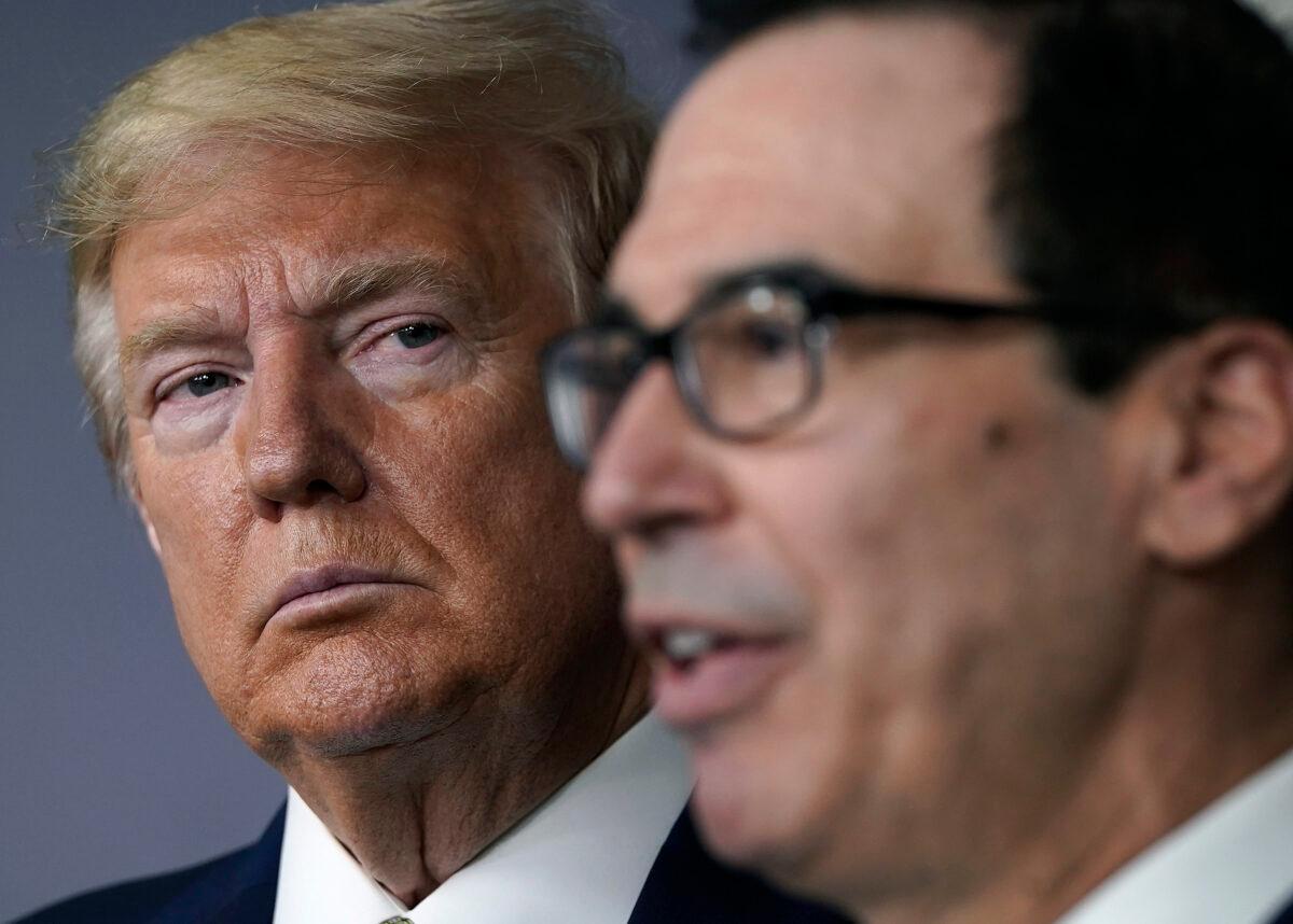 President Donald Trump listens to Secretary of the Treasury Steven Mnuchin speak during a briefing about the coronavirus in the press briefing room at the White House on March 17, 2020. (Drew Angerer/Getty Images)
