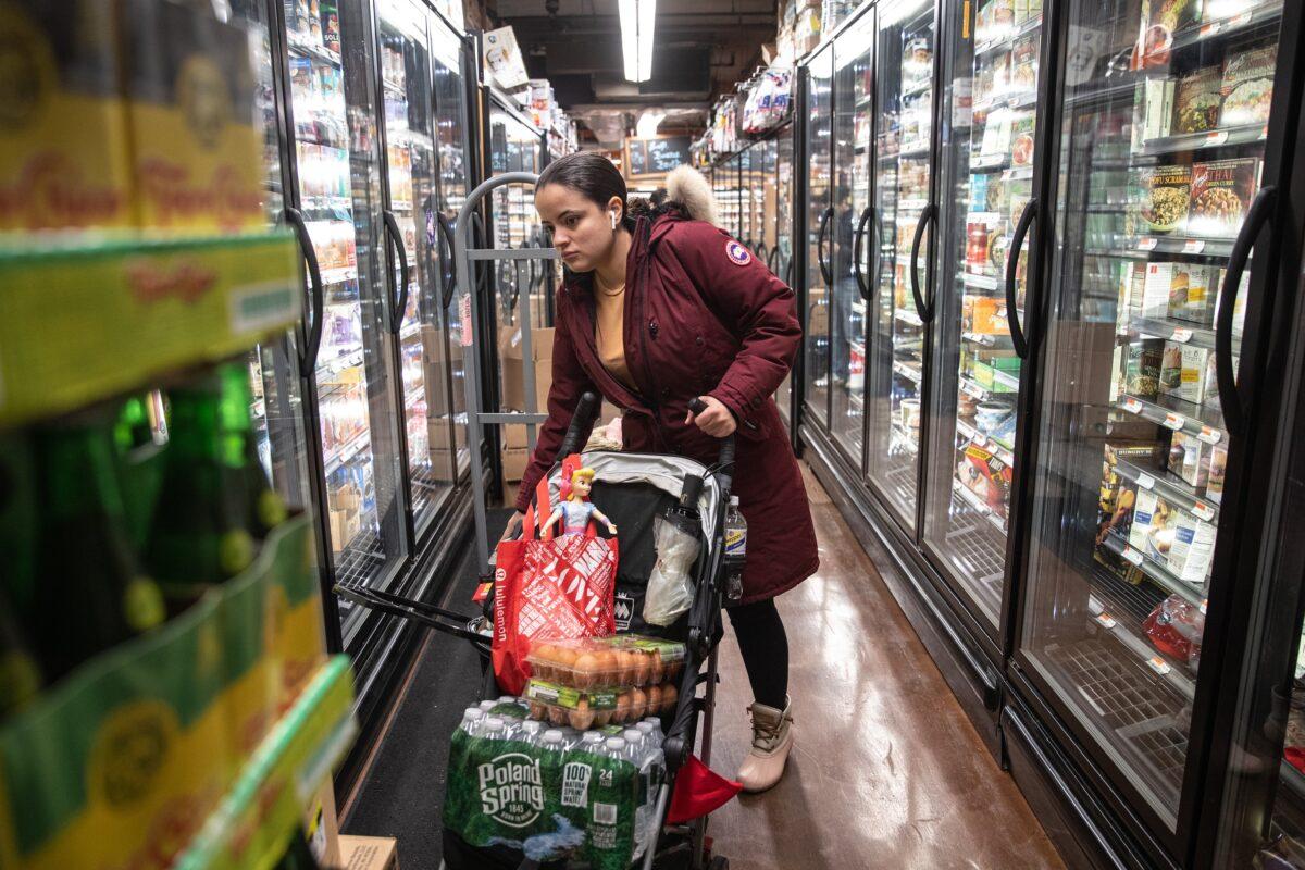 A woman shops at a grocery store in New York City on March 13, 2020. (Jeenah Moon/Getty Images)