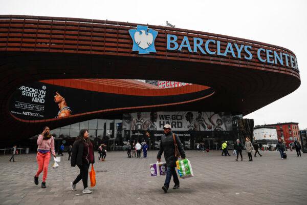 Pedestrians walk past the Barclays Center, which is home to the Brooklyn Nets, in the Brooklyn borough of New York City on March 12, 2020. (John Minchillo/AP Photo)