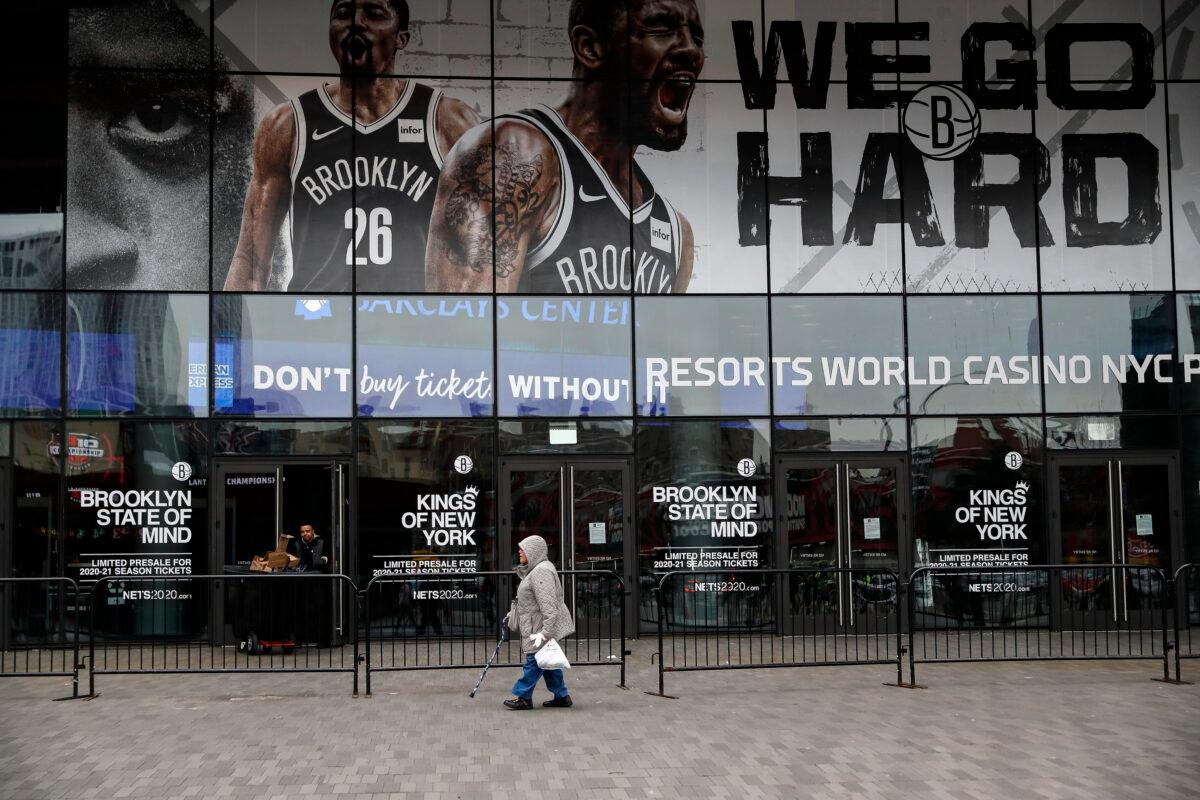 A pedestrian passes an entrance to the Barclays Center in the Brooklyn borough of New York City on March 12, 2020. (John Minchillo/AP Photo)