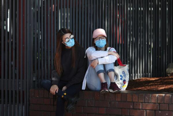 Women wear protective face masks amidst fears of the coronavirus disease (COVID-19) in Sydney, Australia, on March 18, 2020. (Loren Elliott/Reuters)