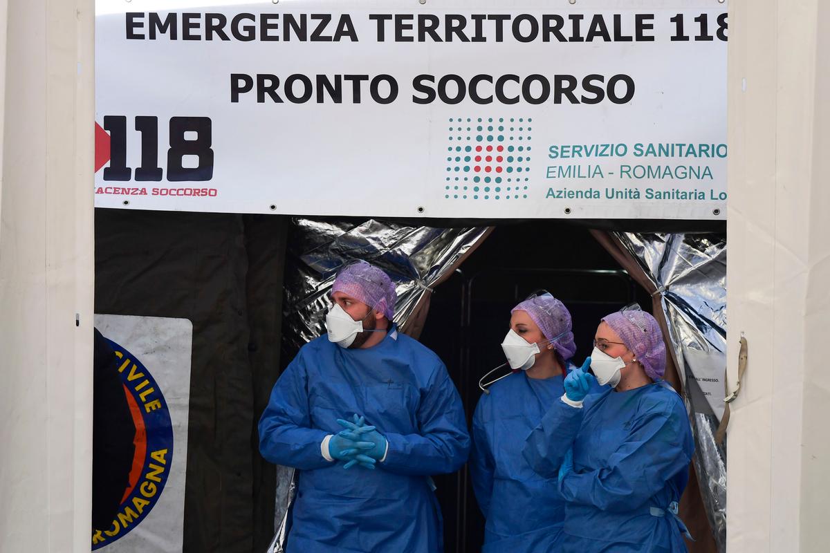 Medical staff wait outside a sanitary tent in Piacenza, next to the city hospital, on Feb. 26, 2020. (©Getty Images | <a href="https://www.gettyimages.com/detail/news-photo/medical-staff-wait-outside-a-sanitary-tent-installed-in-news-photo/1203456998?adppopup=true">MIGUEL MEDINA</a>)
