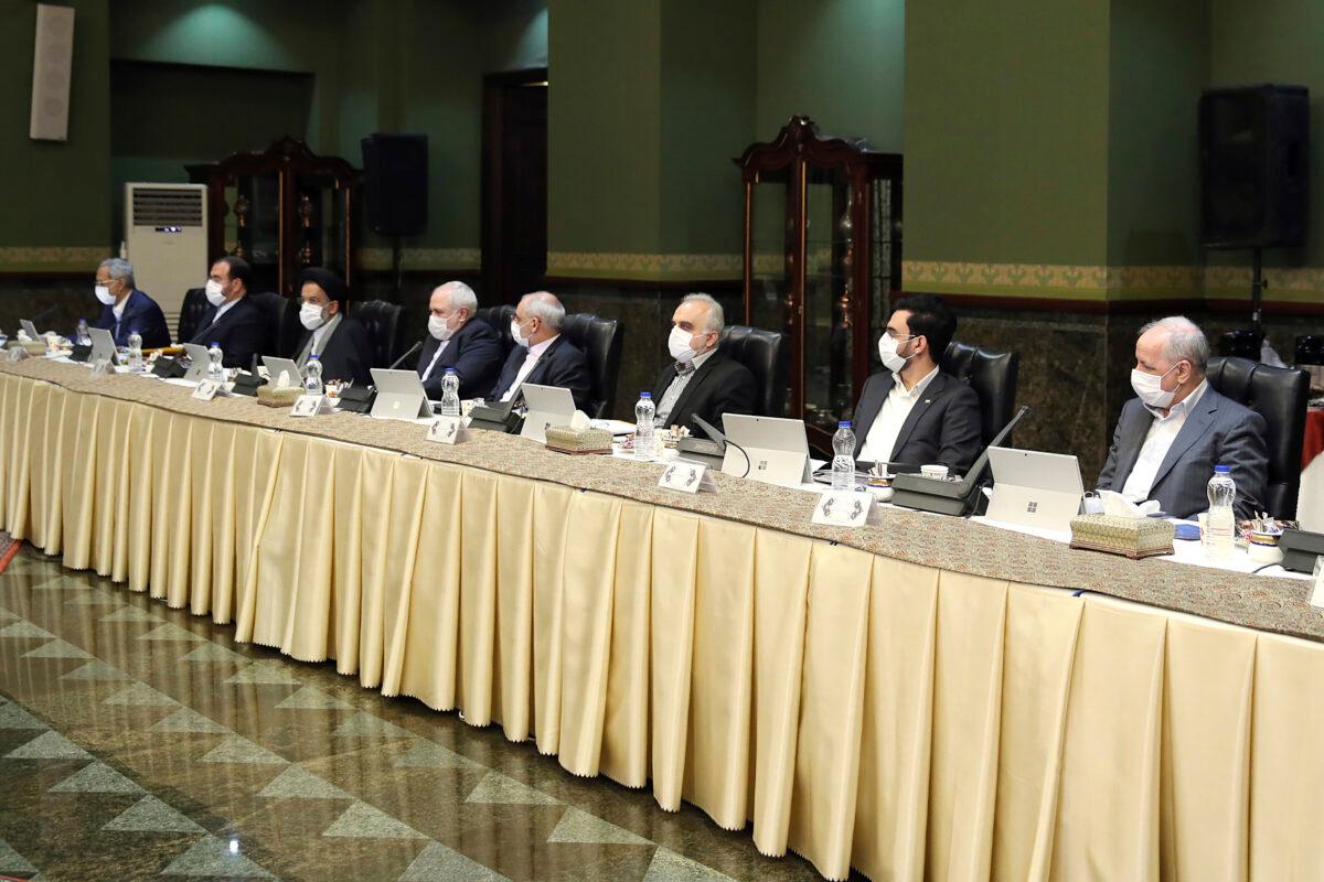 Cabinet members wearing masks attend their meeting in Tehran, Iran, on March 18, 2020. (Office of the Iranian Presidency via AP)