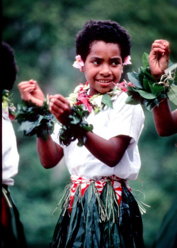 A young girl participates in a Fijian meke, a song and dance performance that tells a story. (Copyright Fred J. Eckert)