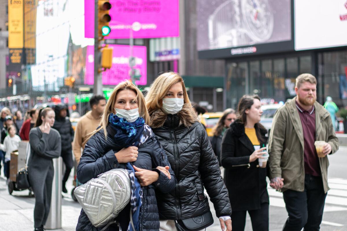 People wear masks near Times Square, New York City, on March 11, 2020. (Chung I Ho/The Epoch Times)