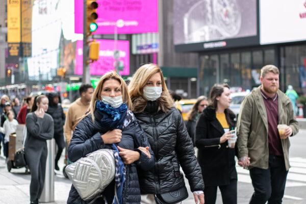 People wear masks near Times Square, New York, on March 11, 2020. (Chung I Ho/The Epoch Times)