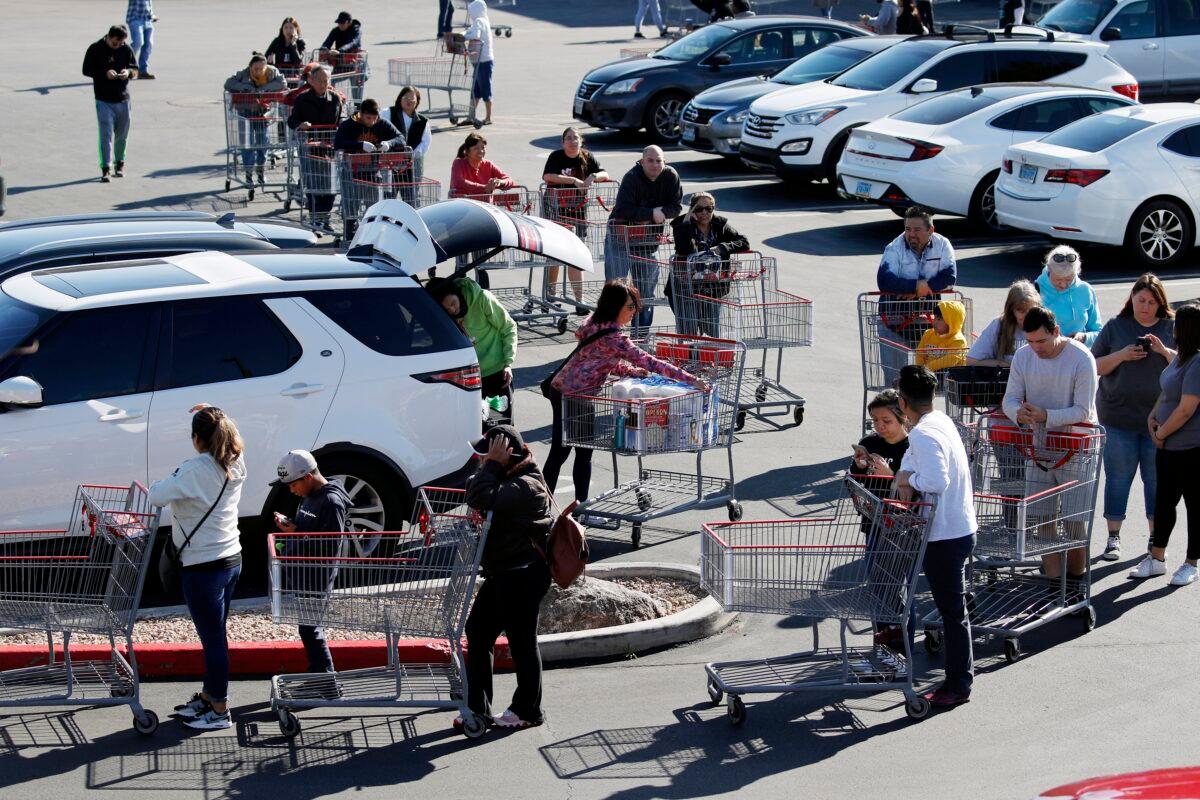 A line of people waiting to buy supplies amid coronavirus fears snakes through a parking lot at a Costco in Las Vegas on March 14, 2020. (John Locher/AP Photo)