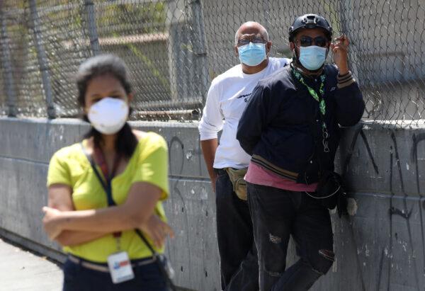 People wearing protective masks on the streets after the start of quarantine in response to the spread of coronavirus disease (COVID-19) in Caracas, Venezuela on March 17, 2020. {Manaure Quintero/Reuters)