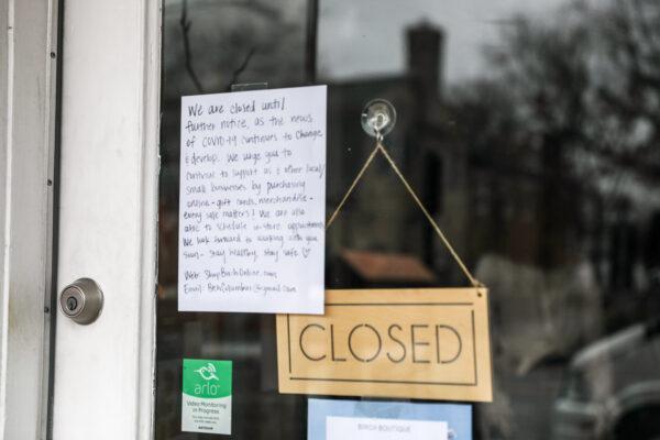 A sign announcing the closure until further notice due to the coronavirus hangs on the door of clothing store Birch in the City of Worthington in Columbus, Ohio, on March 17, 2020. (Charlotte Cuthbertson/The Epoch Times)