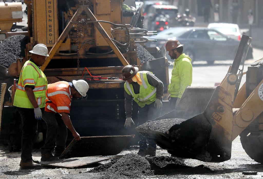 Construction workers grade asphalt to pave a road in San Francisco, Calif., on Oct. 5, 2018. (Justin Sullivan/Getty Images)