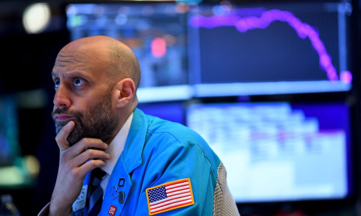 A trader works during the opening bell at the New York Stock Exchange (NYSE) on Wall Street in New York City on March 19, 2020. (Johannes Eisele/AFP via Getty Images)