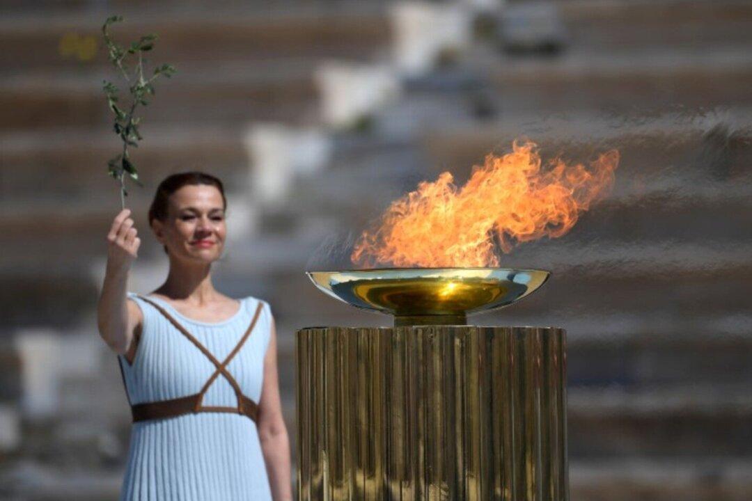 Tokyo 2020 Organizers Receive Olympic Flame for Troubled Games