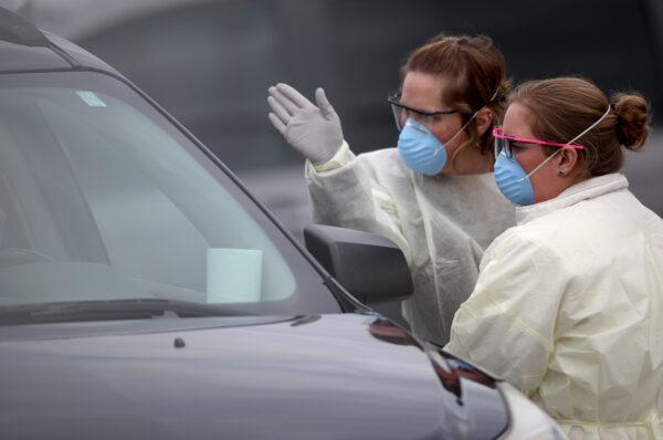 Nurses screen patients for COVID-19 testing at a drive-up location outside Medstar St. Mary's Hospital in Leonardtown, Maryland, on March 17, 2020. (Win McNamee/Getty Images)