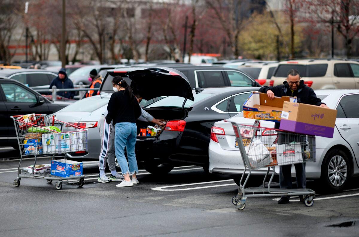 Customers sort their shopping outside a Costco store in New York City on March 19, 2020. (Johannes Eisele/AFP via Getty Images)