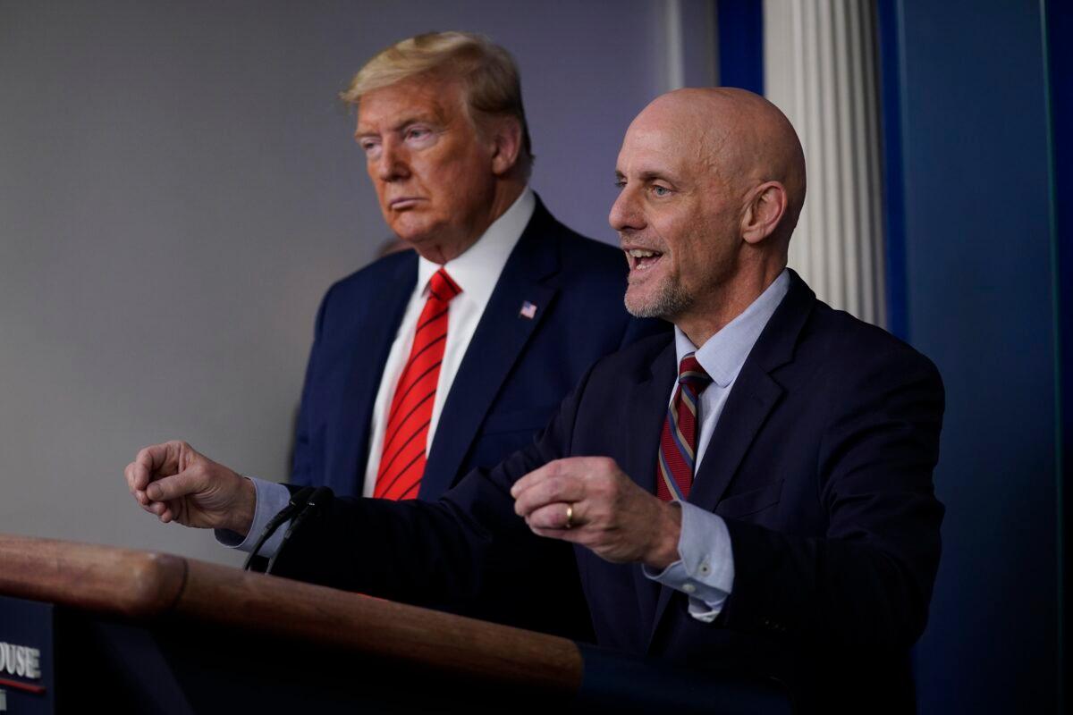 President Donald Trump, left, listens as Food and Drug Administration Commissioner Dr. Stephen Hahn speaks during press briefing with the coronavirus task force, at the White House in Washington on March 19, 2020. (Evan Vucci/AP Photo)