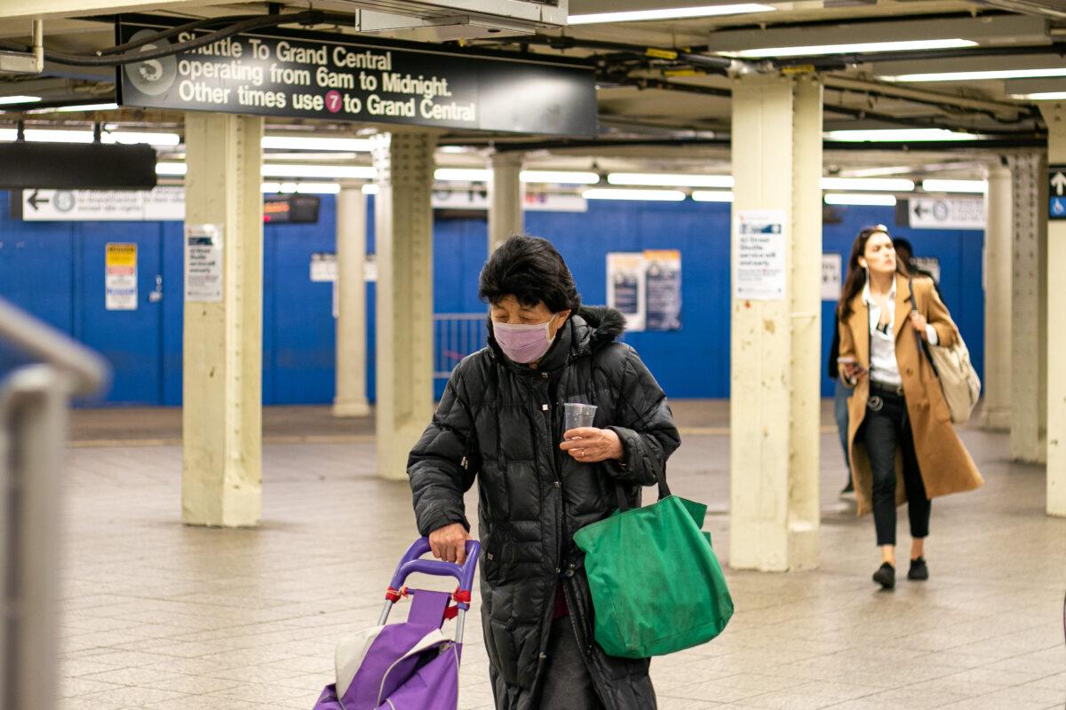 A woman wears a mask in the Times Square subway station, New York, on March 11, 2020. (Chung I Ho/The Epoch Times)