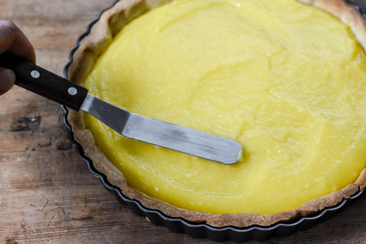 Fill the prepared crust with the lemon custard and return to the oven to finish. (Audrey Le Goff)