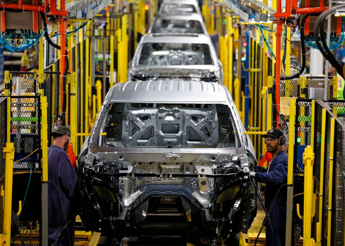 Workers assemble cars at the newly renovated Ford's Assembly Plant in Chicago on June 24, 2019. (Jim Young/AFP via Getty Images)