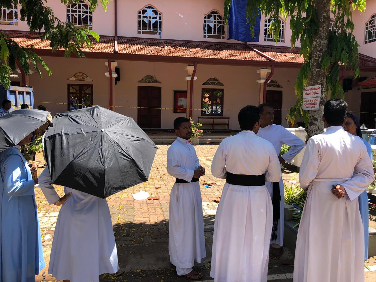 Clergy at the bombed church in Negombo. (Tim Johnson)