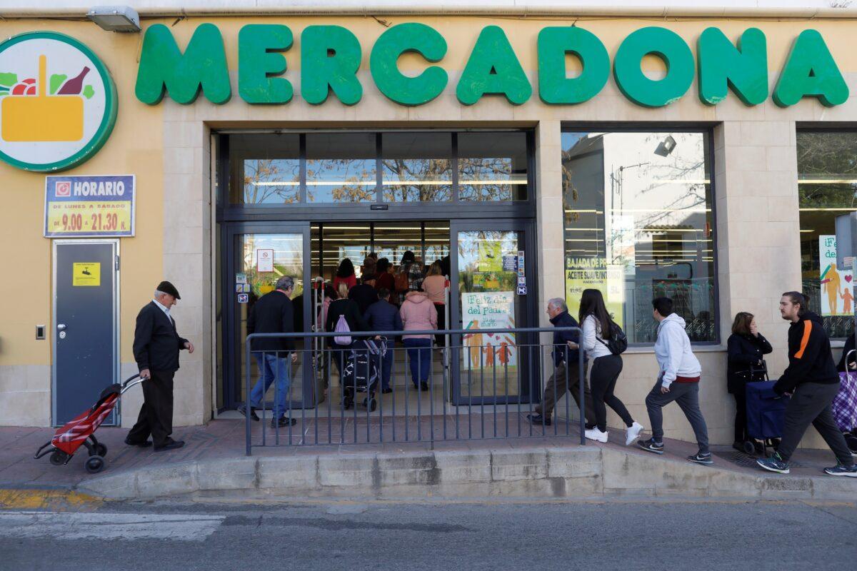 People queue to enter a supermarket amid growing concerns over the COVID-19 outbreak, in Ronda, Spain, on March 14, 2020. (Jon Nazca/Reuters)