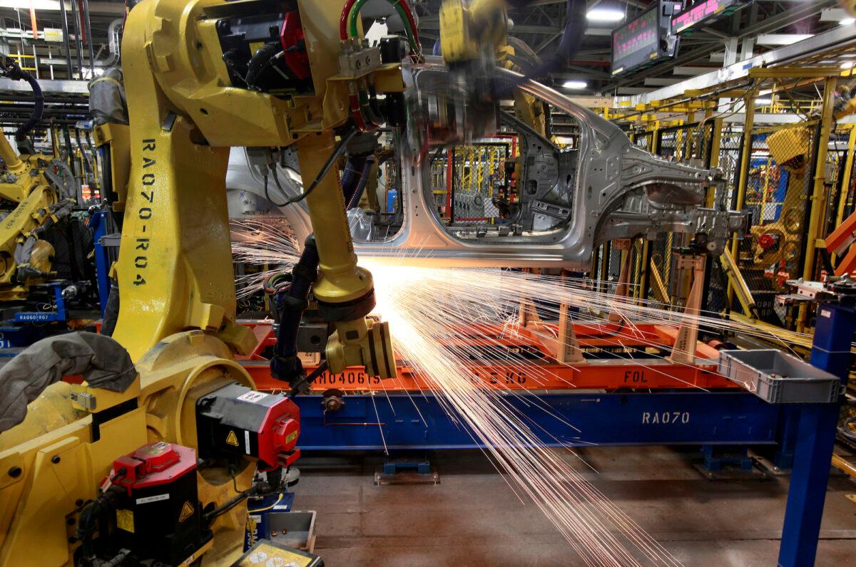 Robots weld a Chevrolet Sonic at the General Motors Orion Assembly plant in Michigan, on May 19, 2011. (AP Photo/Paul Sancya/File Photo)