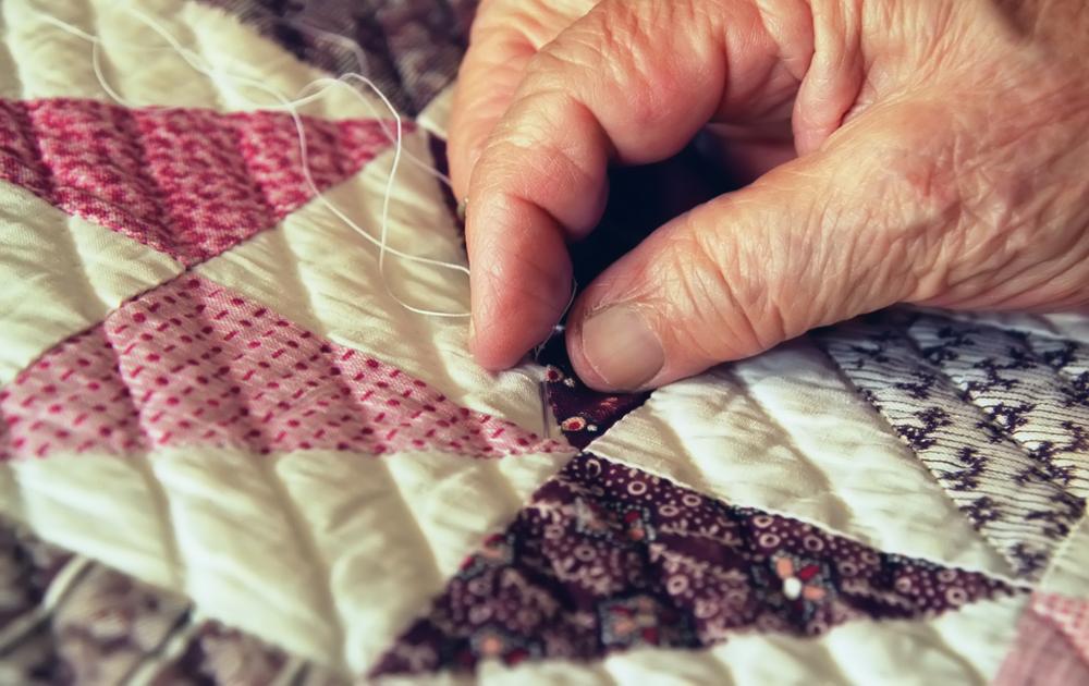 Illustration - Shutterstock | <a href="https://www.shutterstock.com/image-photo/close-elderly-womans-hand-busy-quilting-2562545">Mary Terriberry</a>