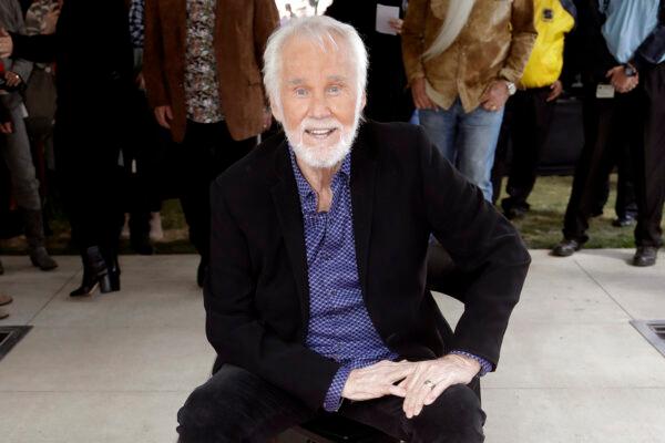 Kenny Rogers poses with his star on the Music City Walk of Fame in Nashville, Tenn. on Oct. 24, 2017. (AP Photo/Mark Humphrey, File)