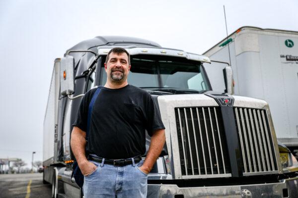 Truck driver James Huff stands next to his rig at the TA Truck Service truck stop in London, Ohio, on March 19, 2020. (Charlotte Cuthbertson/The Epoch Times)