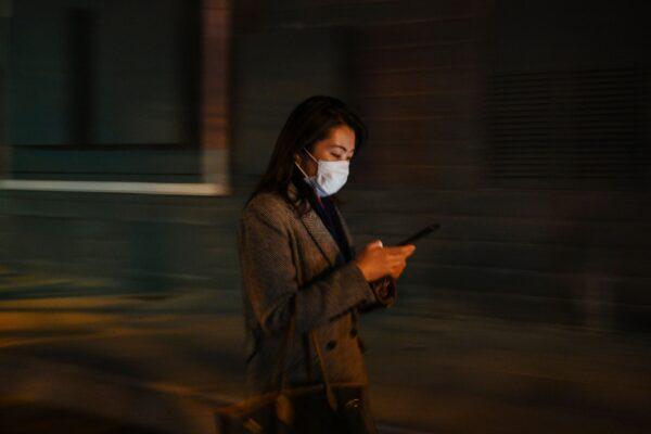  A woman is checking her cellphone in Shanghai, China on March 17, 2020. (HECTOR RETAMAL/AFP via Getty Images)