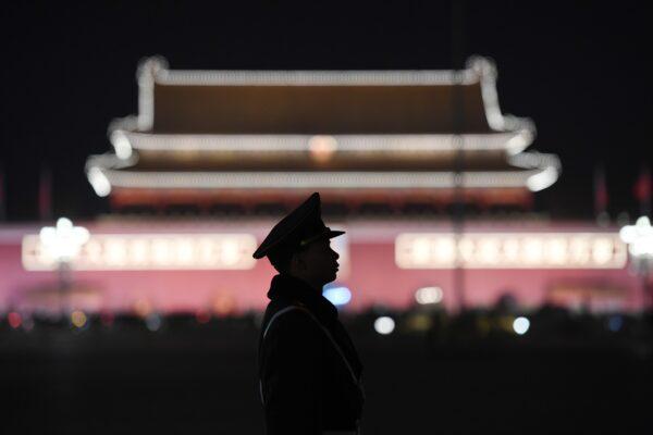 A paramilitary police officer stands guard in Tiananmen Square in Beijing, China, on March 11, 2018. (Greg Baker/AFP via Getty Images)